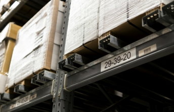 a close up of a metal shelf with boxes on it