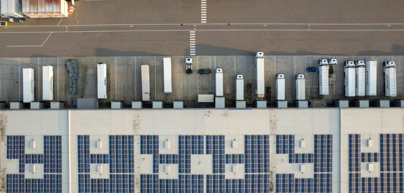 An aerial view of a parking lot with cars