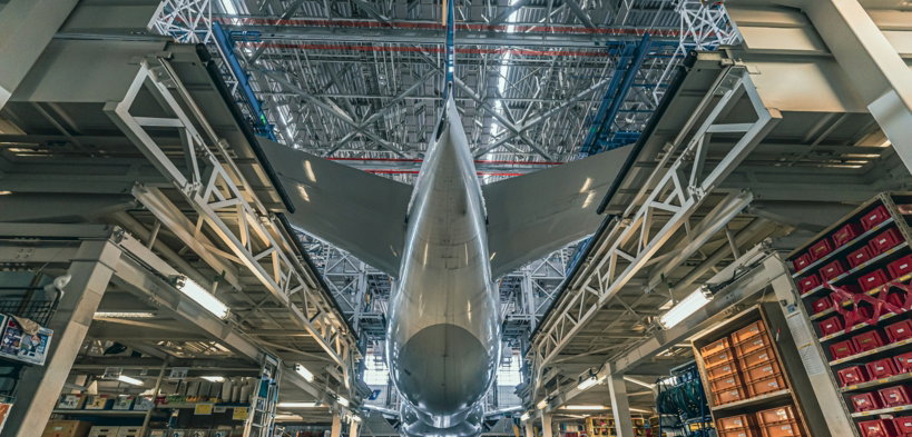 a large jetliner sitting inside of a hangar
